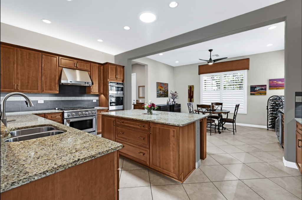 Dark wood kitchen with new gray backsplash tile design and new gray paint in two colors with new cabinet modifications for microwave and oven