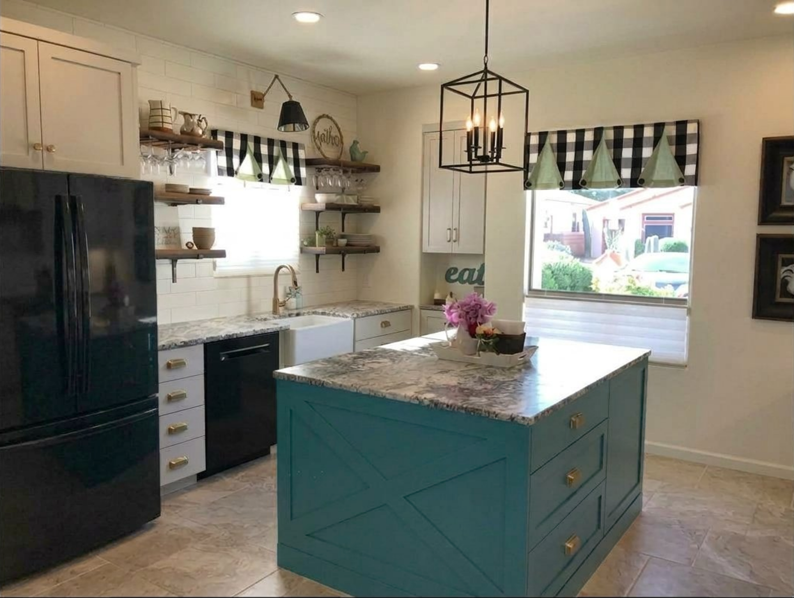 kitchen farmhouse style teal island green and gingham valances. white cabinets gold hardware. white subway tiles. black appliances.